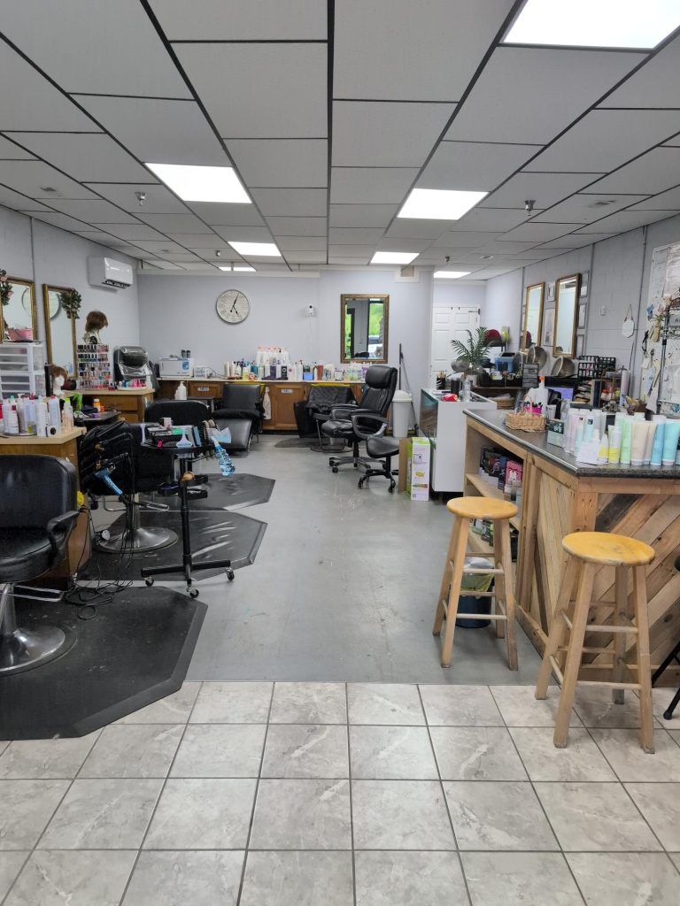 Inside Bruce's Cut & Curl, styling stations, mirrors and the Paul Mitchell product wall in Cleveland, TN